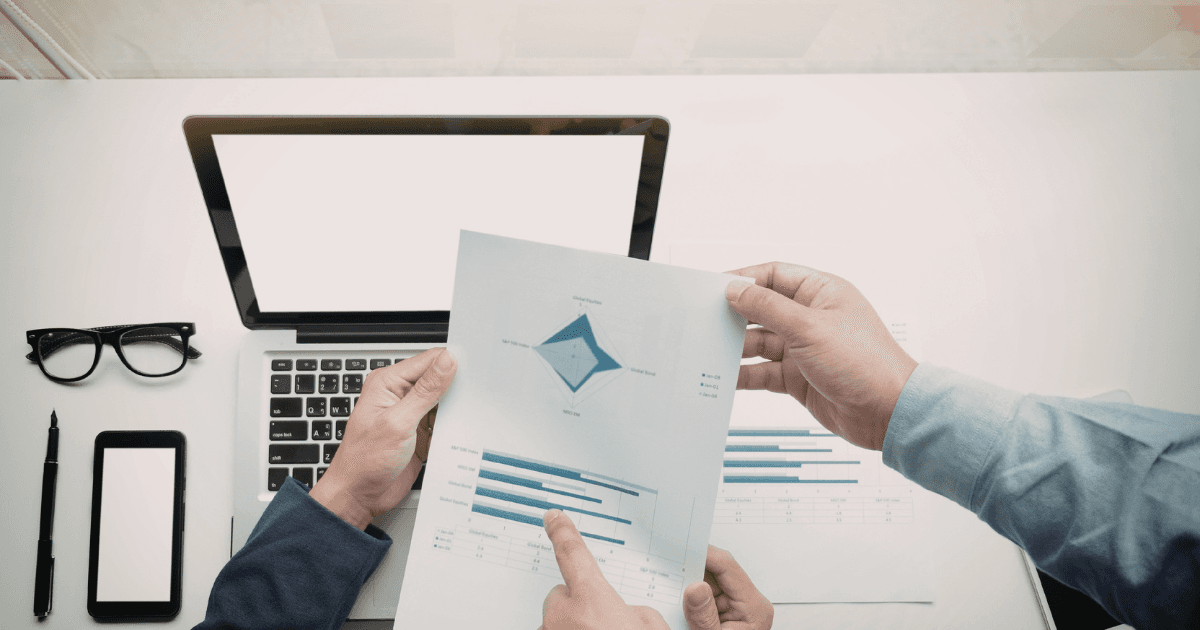 Team reviewing reports — how much does it cost to hire a Latin American freelancer 2026